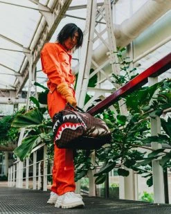 SPRAYGROUND® BAGS SHARKS AND SKULLS DUFFLE